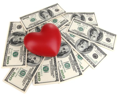 Love and money concept. Heart and American currency isolated on white