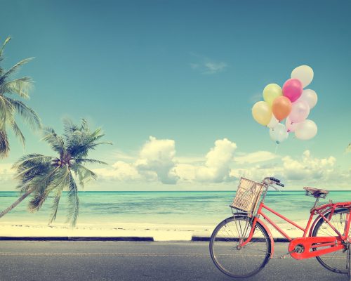 vintage bicycle with balloon on beach blue sky concept of love in summer and wedding honeymoon