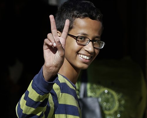 Ahmed Mohamed, 14, gestures as he arrives to his family's home in Irving, Texas, Thursday, Sept. 17, 2015. Ahmed was arrested Monday at his school after a teacher thought a homemade clock he built was a bomb. He remains suspended and said he will not return to classes at MacArthur High School. (AP Photo/LM Otero)